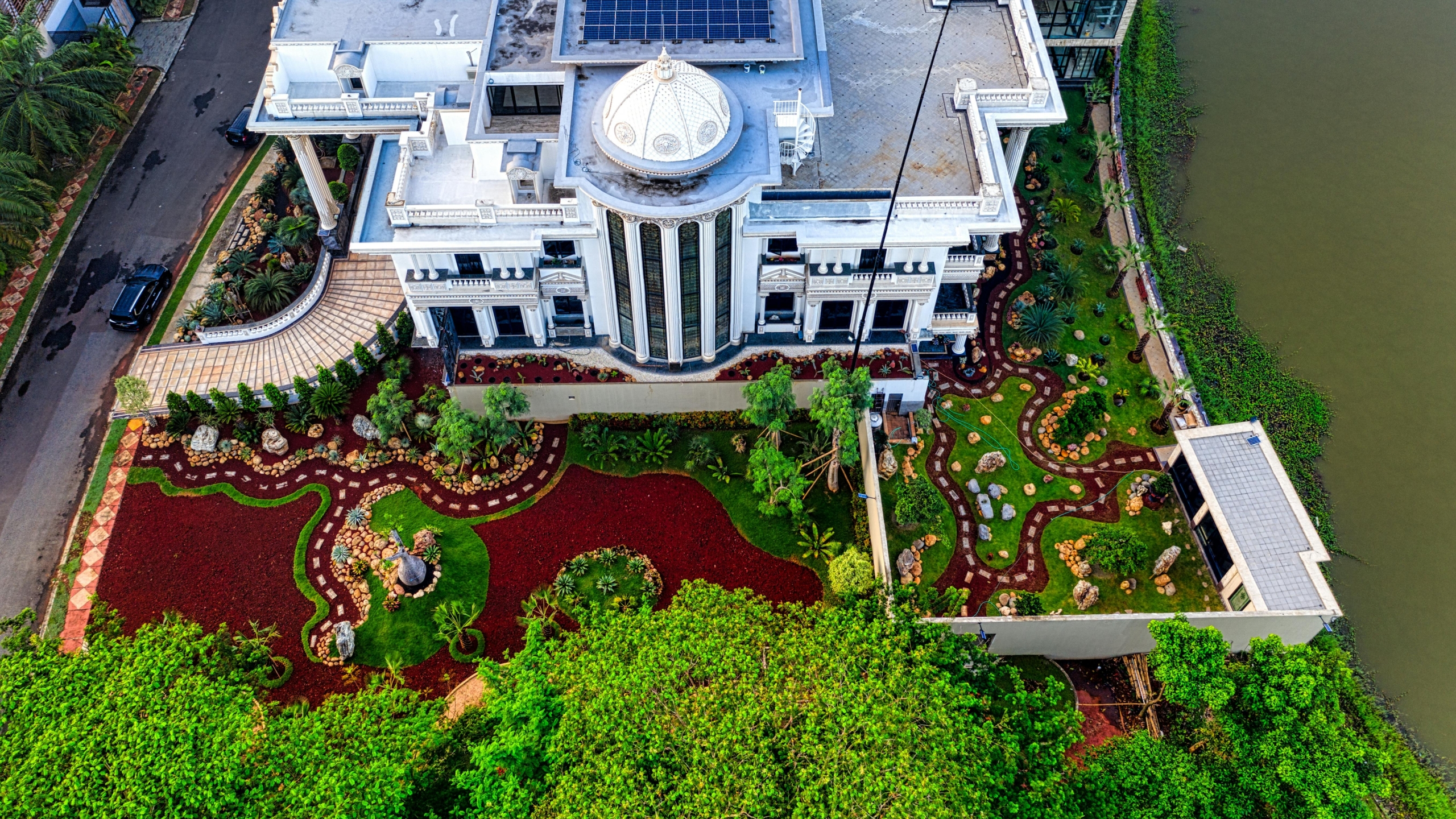 Drone view of a mansion with luxurious garden