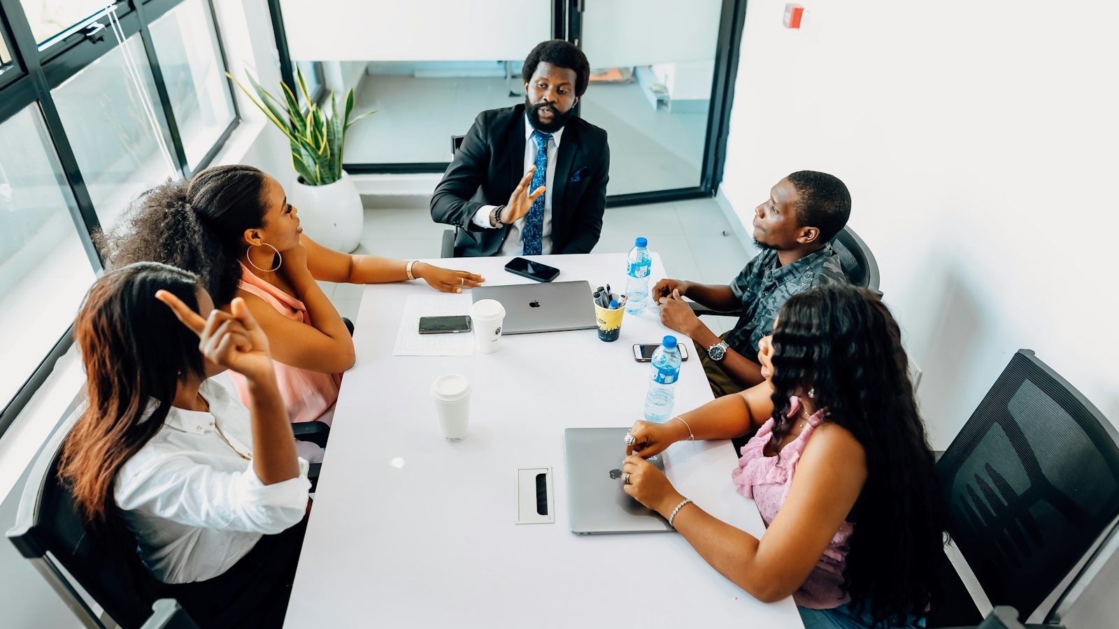 A group of people sitting around a white table