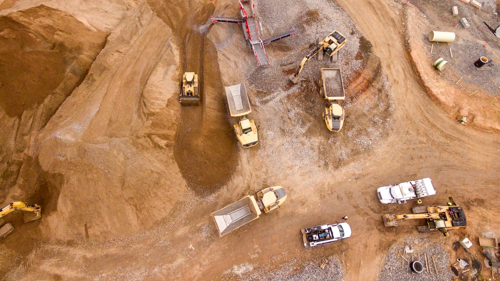 aerial photography of trucks in a building site