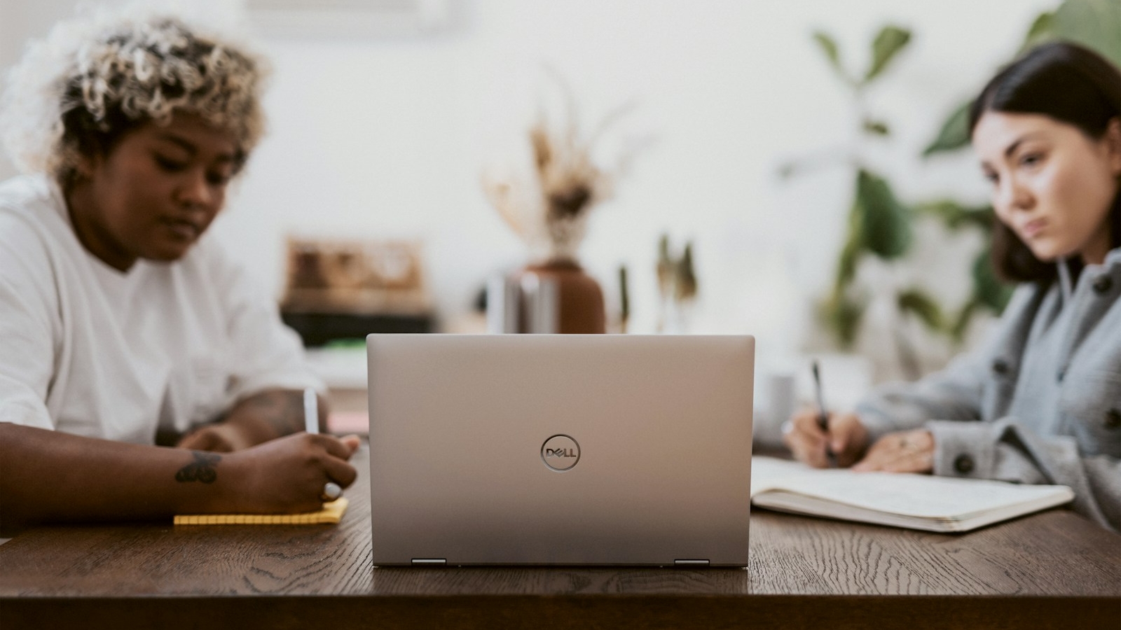 two woman looking at a laptop